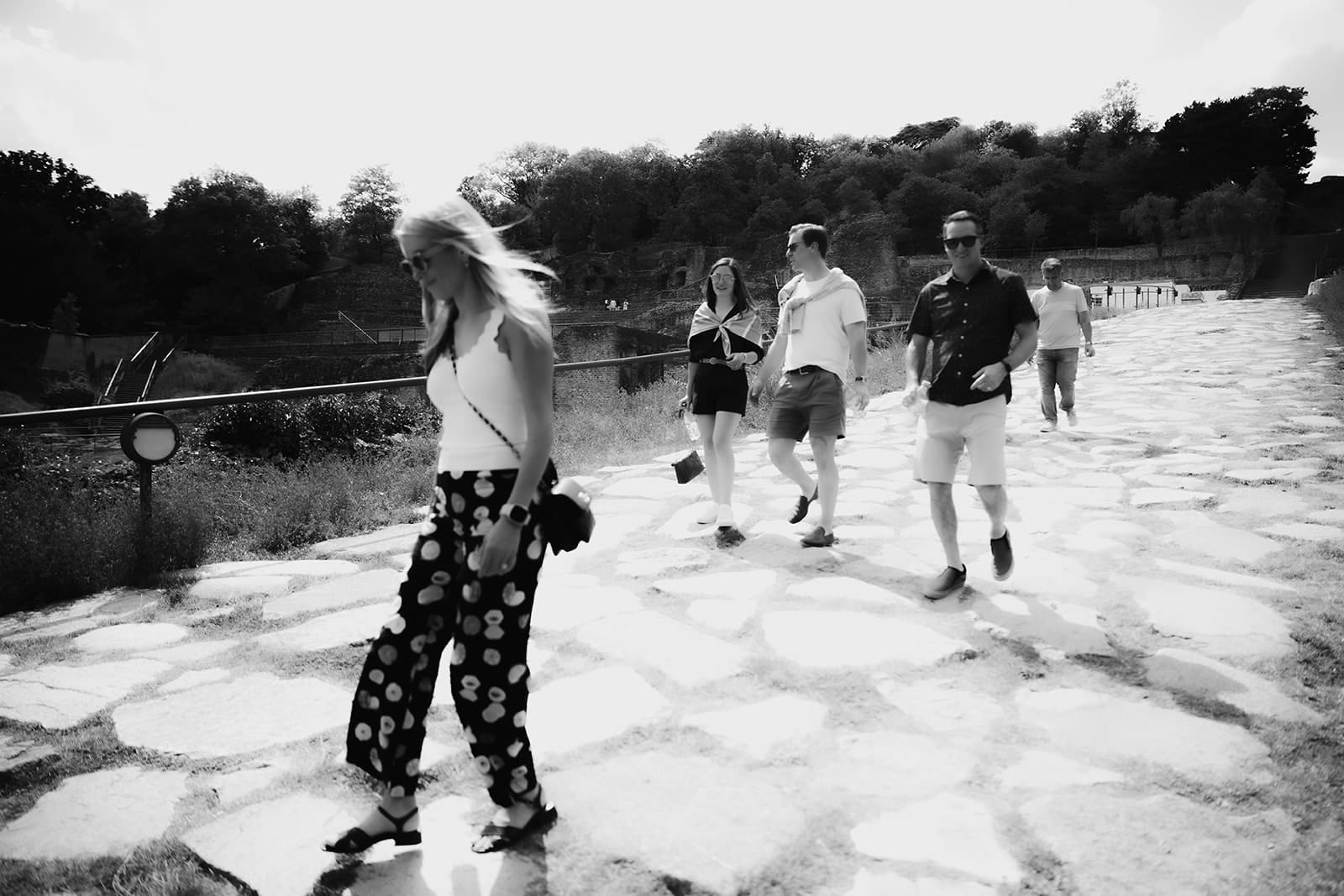 Friends walking along Roman ruins in Lyon during a sunny day