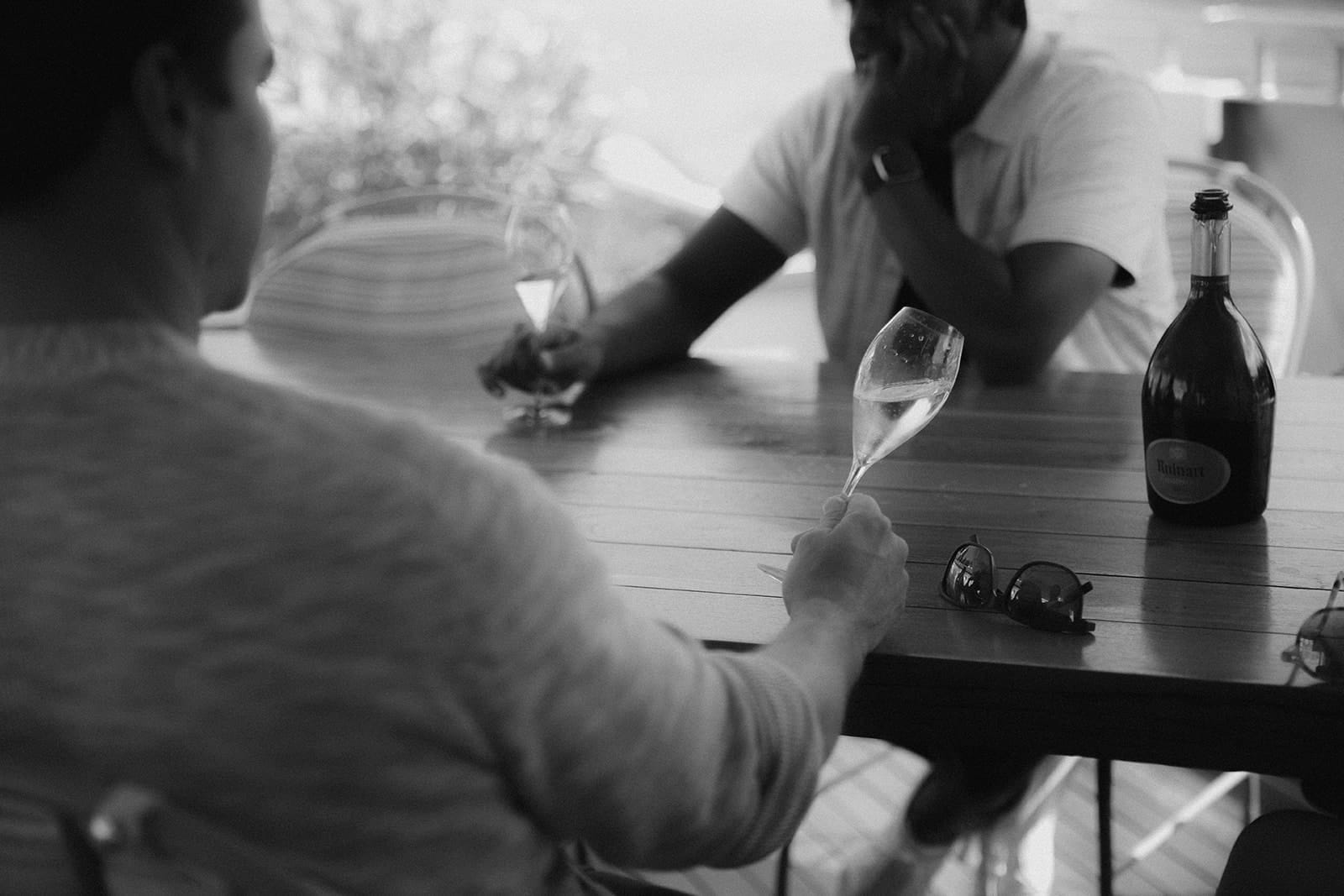 Two men enjoying champagne aboard a luxury boat on the Saône river in Lyon