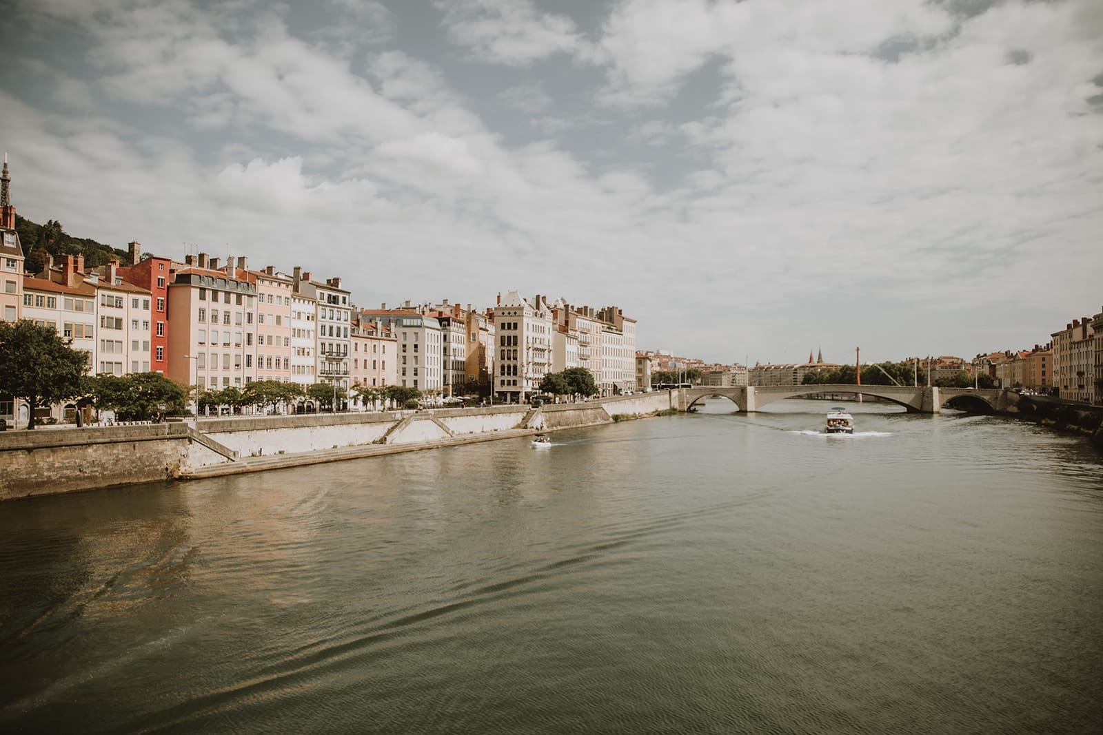 Color view of the Belmond Lilas cruise boat on the Saône River in Lyon